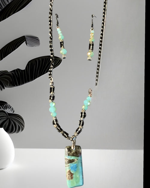 Heartfelt Creations artisan beaded necklace and earring set with turquoise, blue, and brown pendant, accented with crystals.