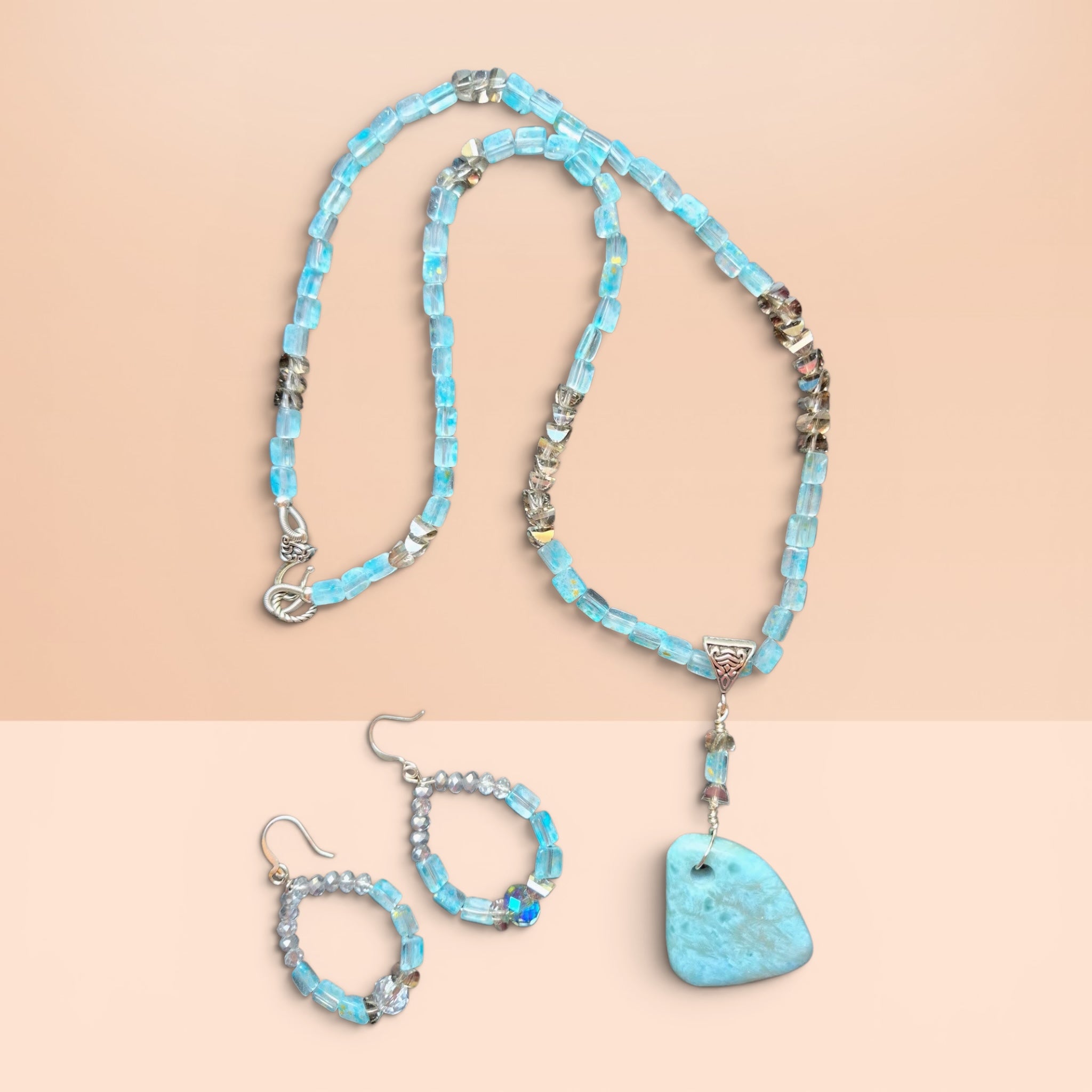 Heartfelt Creations artisan jewelry set with blue beaded necklace, organic pendant, and matching drop earrings.