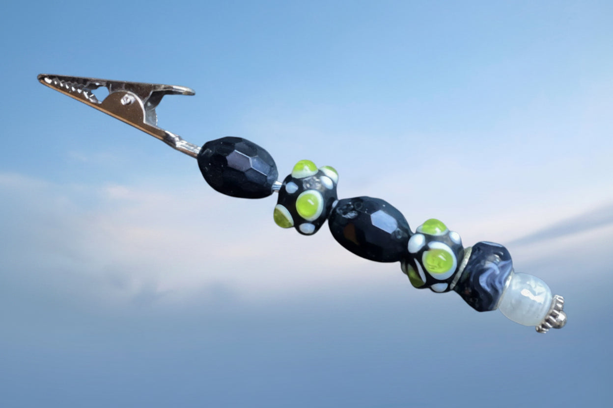 Heartfelt Creations artisanal roach clip featuring black and lime green glass beads on a metal tension clip