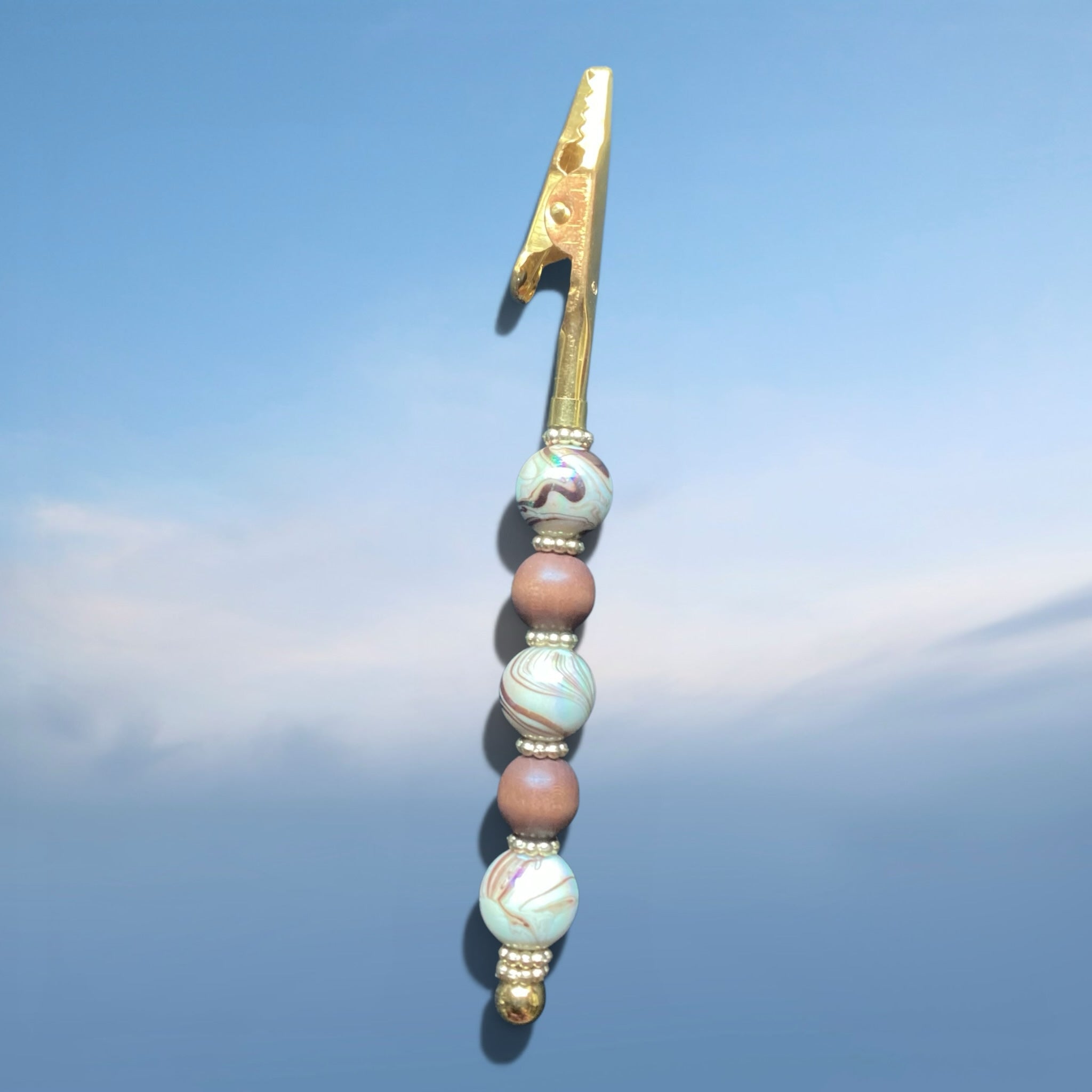 Heartfelt Creations gold-tone metal roach clip with decorative matte brown and marbled glass beads.