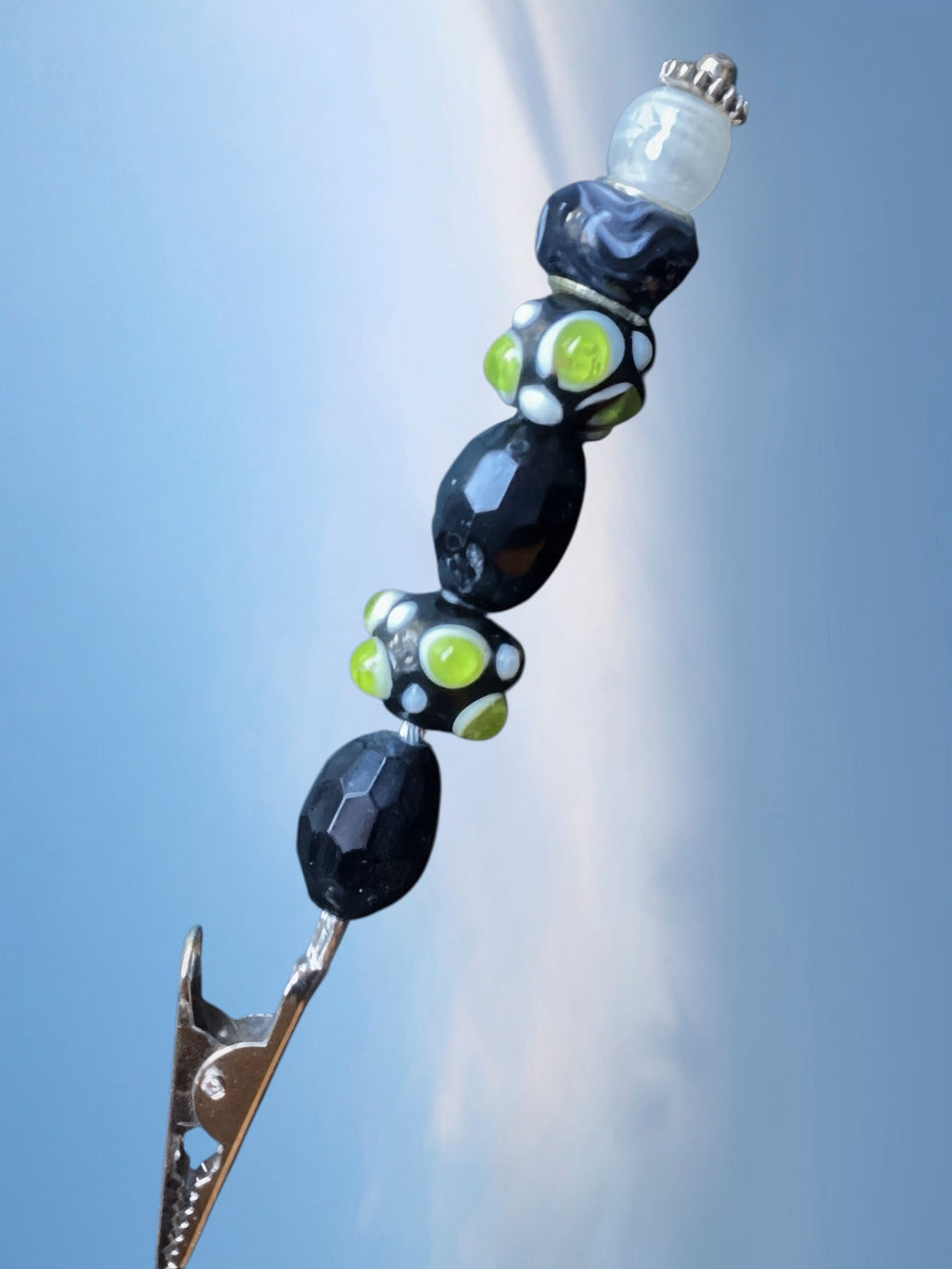 Heartfelt Creations artisanal roach clip featuring black and lime green glass beads on a metal tension clip