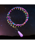Heartfelt Creations multi-colored beaded coil bracelet with pink, turquoise, and gold beads, featuring a silver-tone charm with a lavender teardrop pendant.