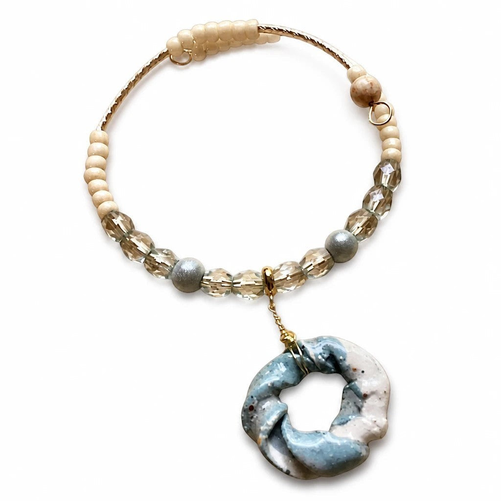 Heartfelt Creations handcrafted necklace with a sage and cream stone pendant, pearl beads, and copper wire accents.