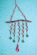 Heartfelt Creations handcrafted beaded wall hanging with a natural branch, floral beads, and green and pink crystals.