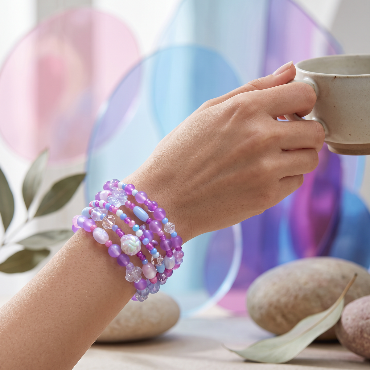 Heartfelt Creations 4-layer wrap bracelet with purple, pink, and blue beads and flower charms on a woman's wrist.