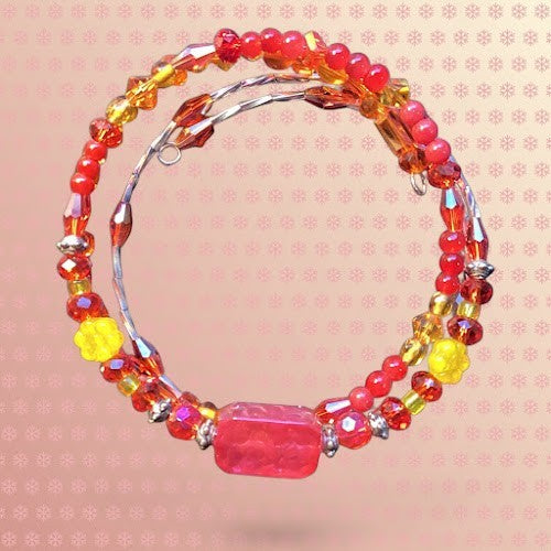 Heartfelt Creations handcrafted wrap bracelet featuring red and yellow glass beads, floral accents, and faceted crystals.