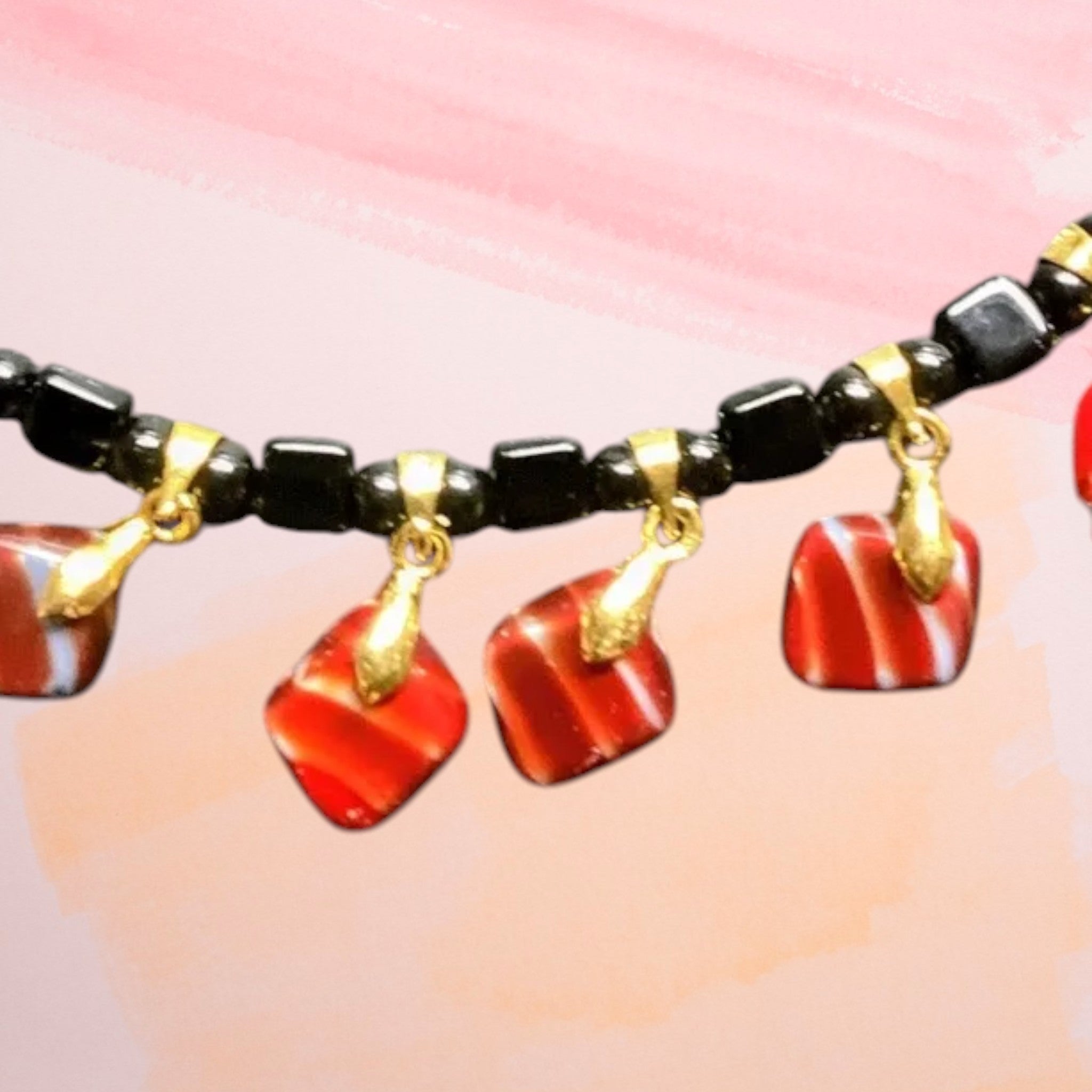 Heartfelt Creations black beaded necklace with red and white striped dangle charms and gold-tone accents.