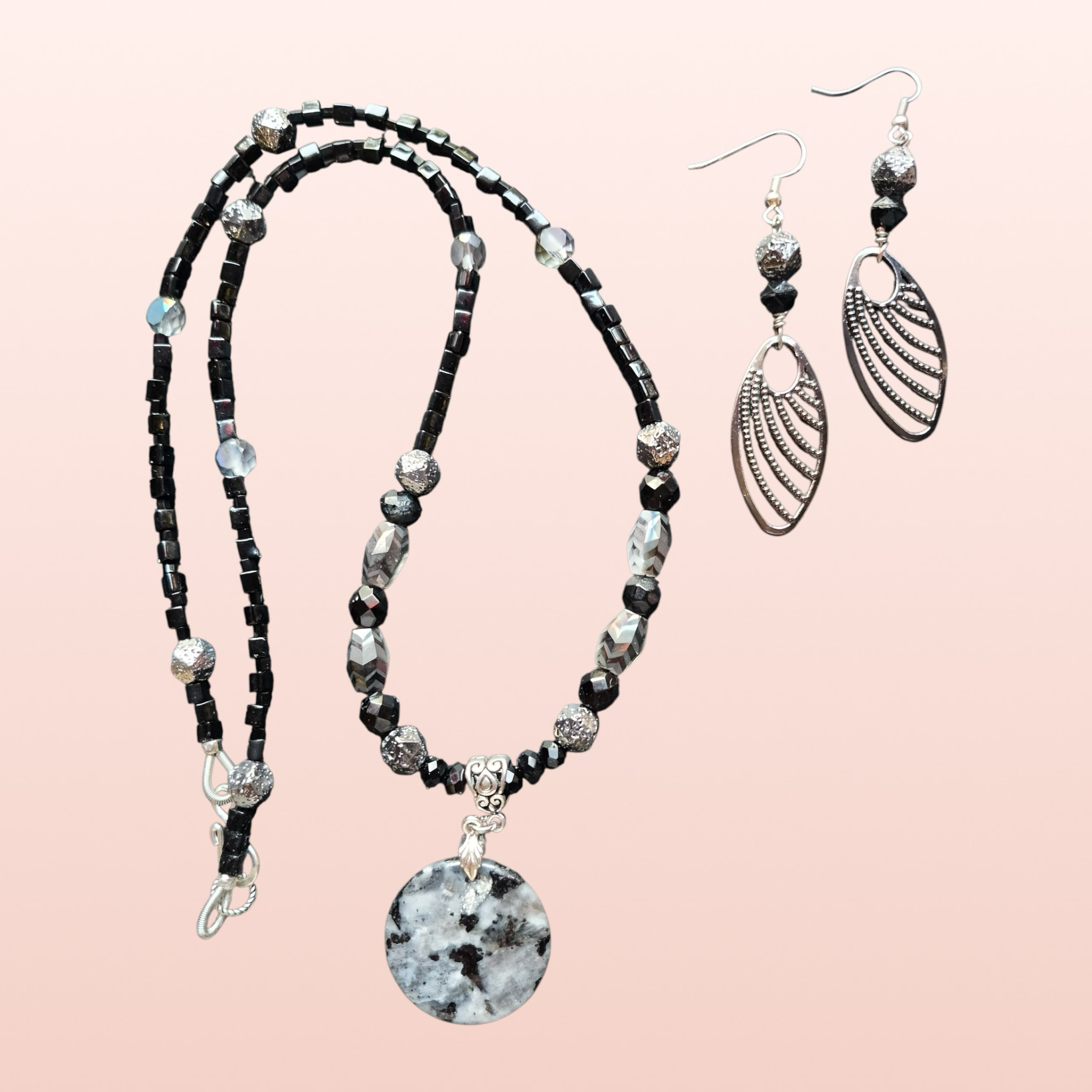 Heartfelt Creations black and silver beaded necklace with marbled pendant and matching dangle earrings.