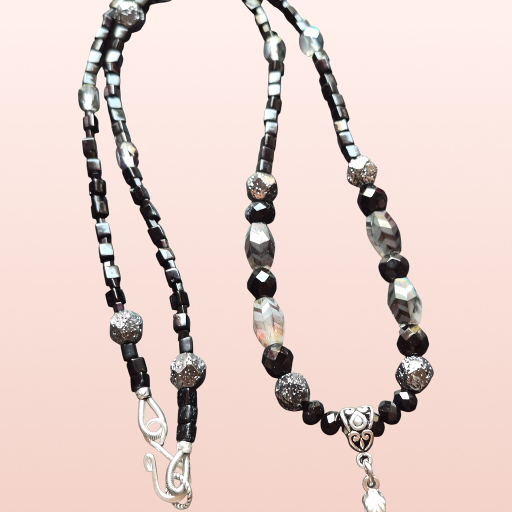 Heartfelt Creations black and silver beaded necklace with pendant and matching earrings. Features faceted black beads, crystal accents, silver spheres, and a marbled stone.