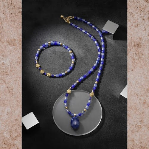 Heartfelt Creations blue beaded necklace and bracelet set with gold-tone floral accents and a smooth blue stone pendant.