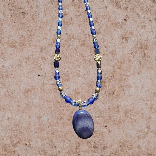 Heartfelt Creations artisan necklace featuring a smooth blue stone pendant with patterned glass beads and gold floral accents