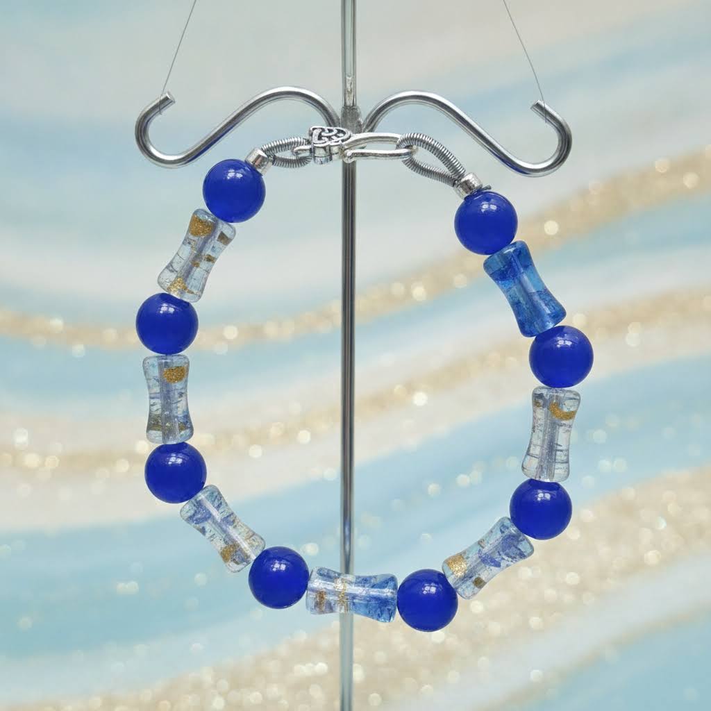 Heartfelt Creations handmade bracelet with cobalt blue round beads and clear barrel-shaped glass beads with gold flecks