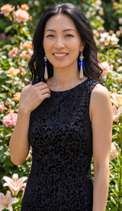 Heartfelt Creations artisan drop earrings with cobalt blue glass spheres and silver twisted teardrop pendants on model