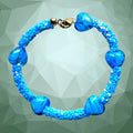 Heartfelt Creations blue beaded bracelet with textured design and blue heart beads, gold-tone clasp.