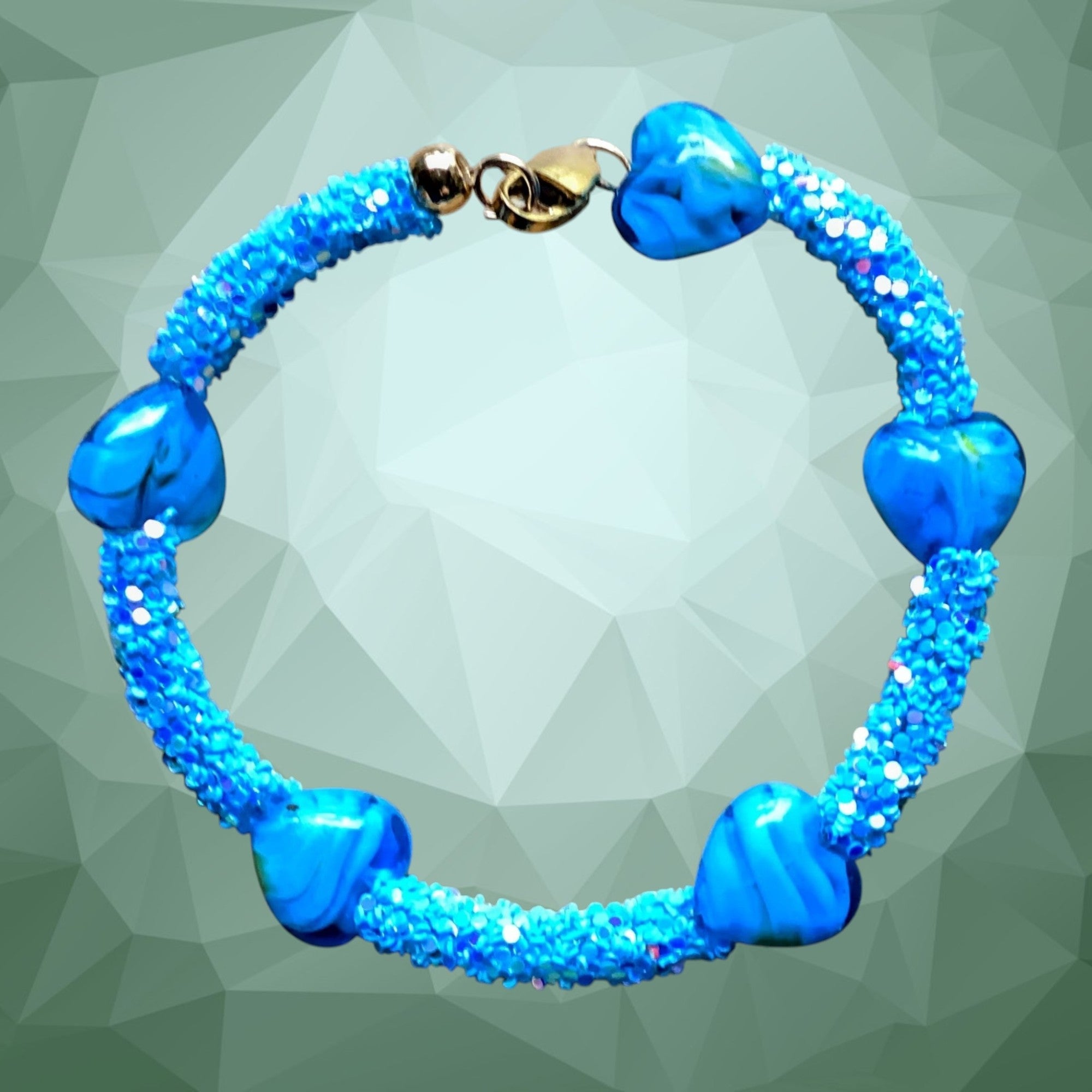 Heartfelt Creations blue beaded bracelet with textured design and blue heart beads, gold-tone clasp.