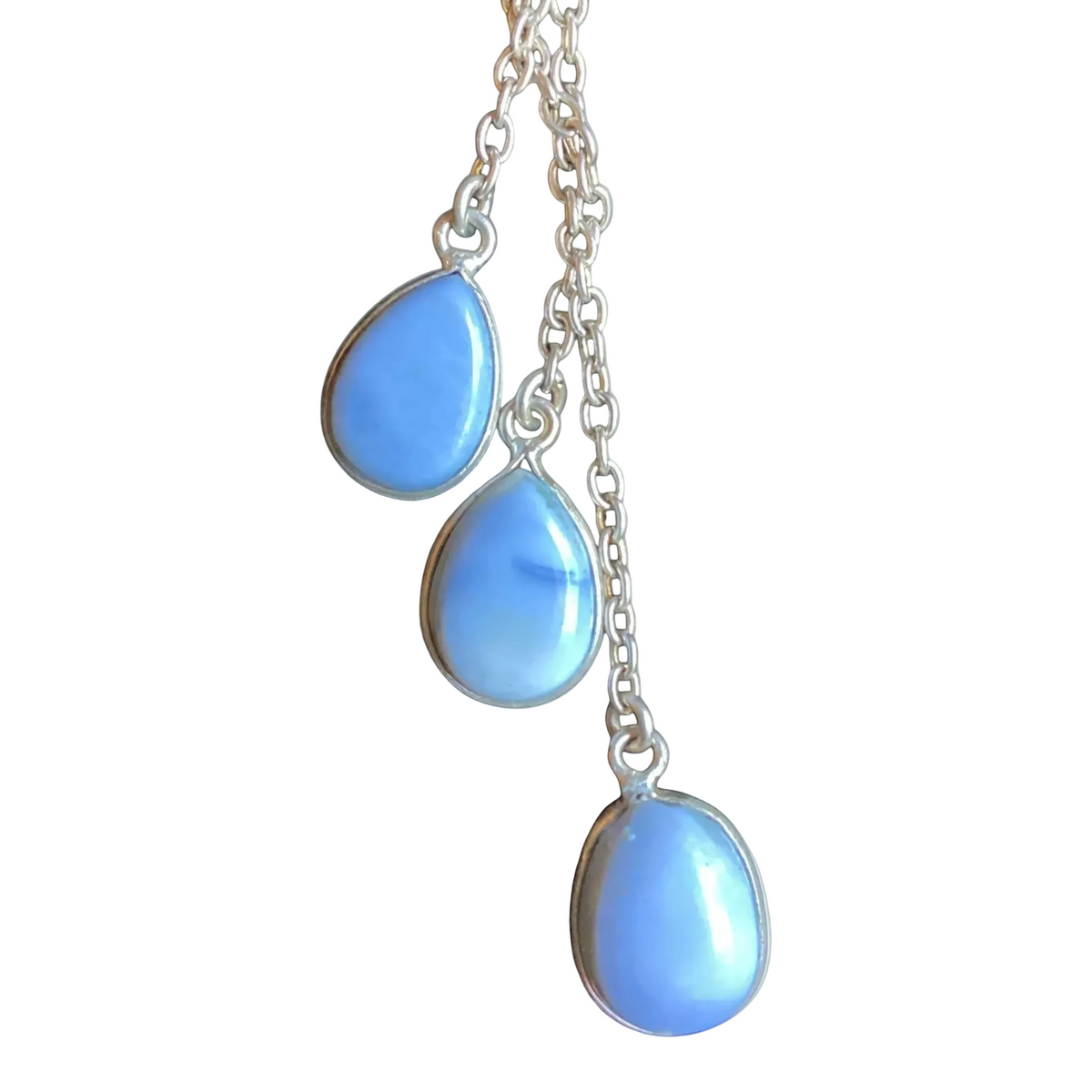 Heartfelt Creations silver-toned dangle necklace featuring three teardrop-shaped light blue cabochon gemstones  suspended from a delicate silver chain.