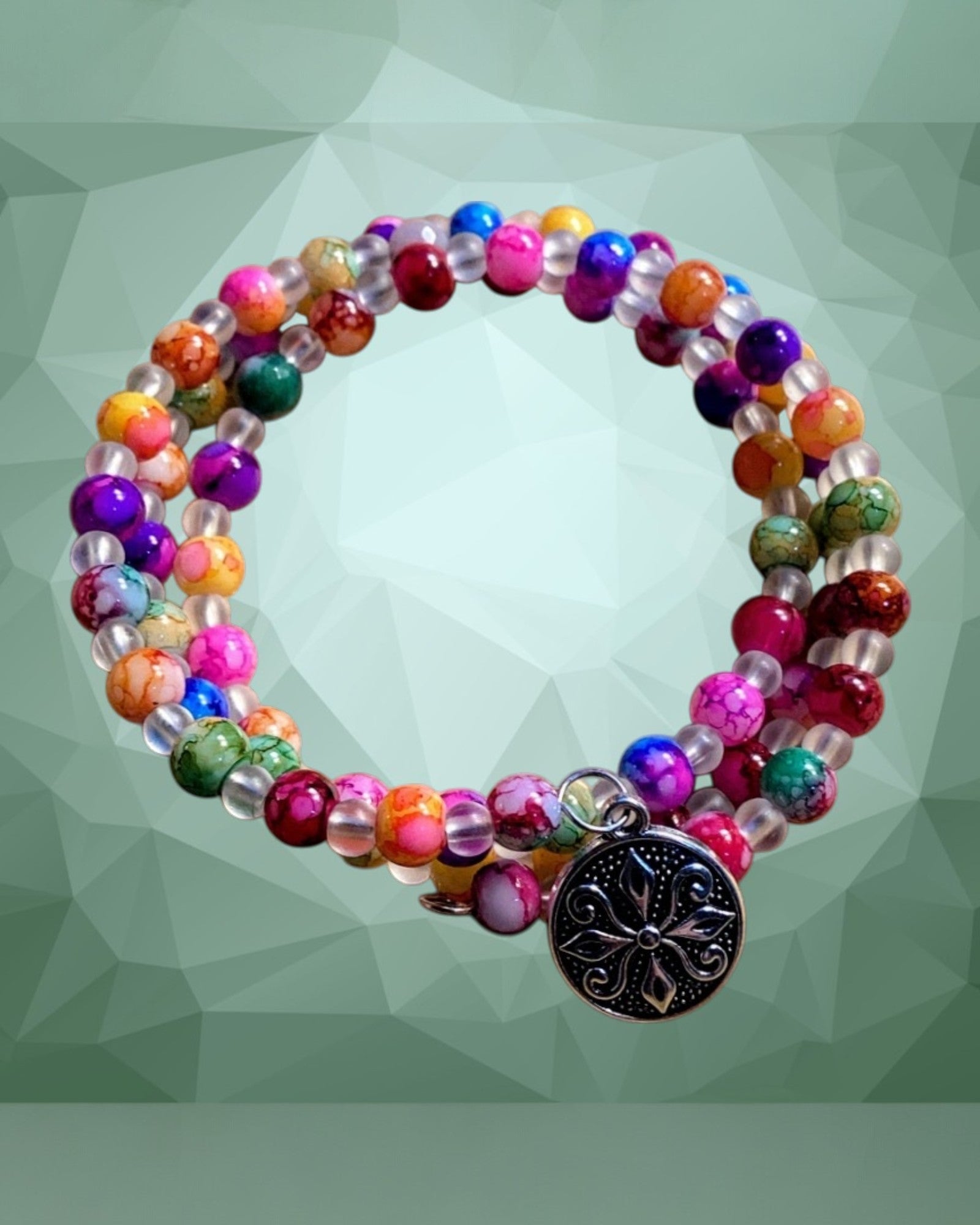Heartfelt Creations bohemian multi-gemstone coil bracelet with silver-tone charm. Features colorful agate beads and clear accent beads.