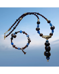 Heartfelt Creations bohemian beaded necklace and bracelet set with deep red, brown, and blue stones. Necklace features a stacked stone pendant.