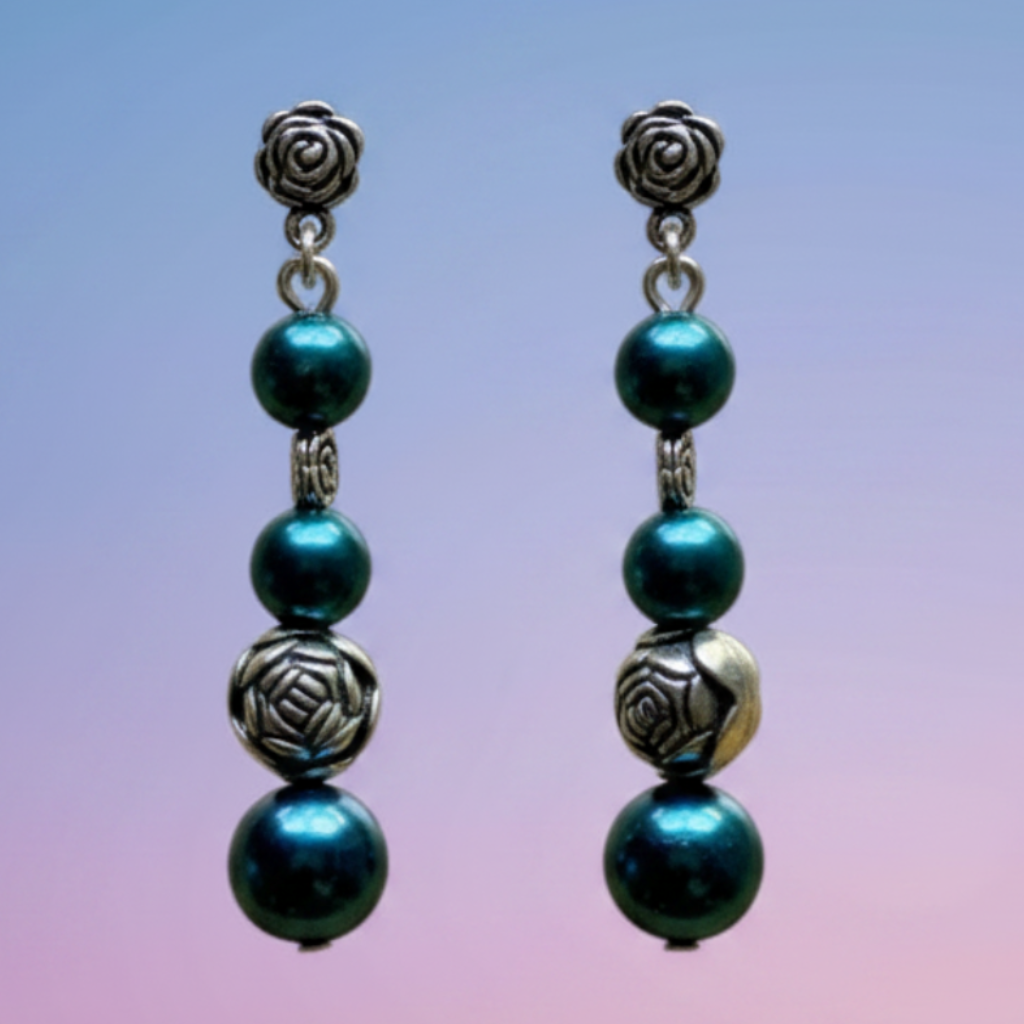 Heartfelt Creations features a handcrafted  silver-toned beaded necklace, with a pendant of three turquoise blue agate druzy stones and matching drop earrings. Heartfelt Creations bohemian jewelry set with teal pearls, silver rose charms, and blue druzy stones.
