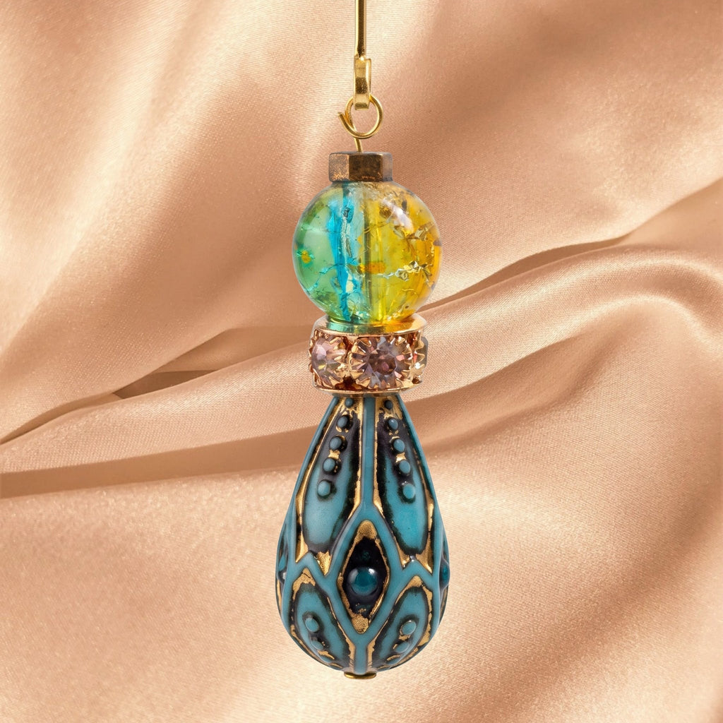 Heartfelt Creations bohemian drop earrings featuring a marbled blue and yellow glass bead and antique teal teardrop.