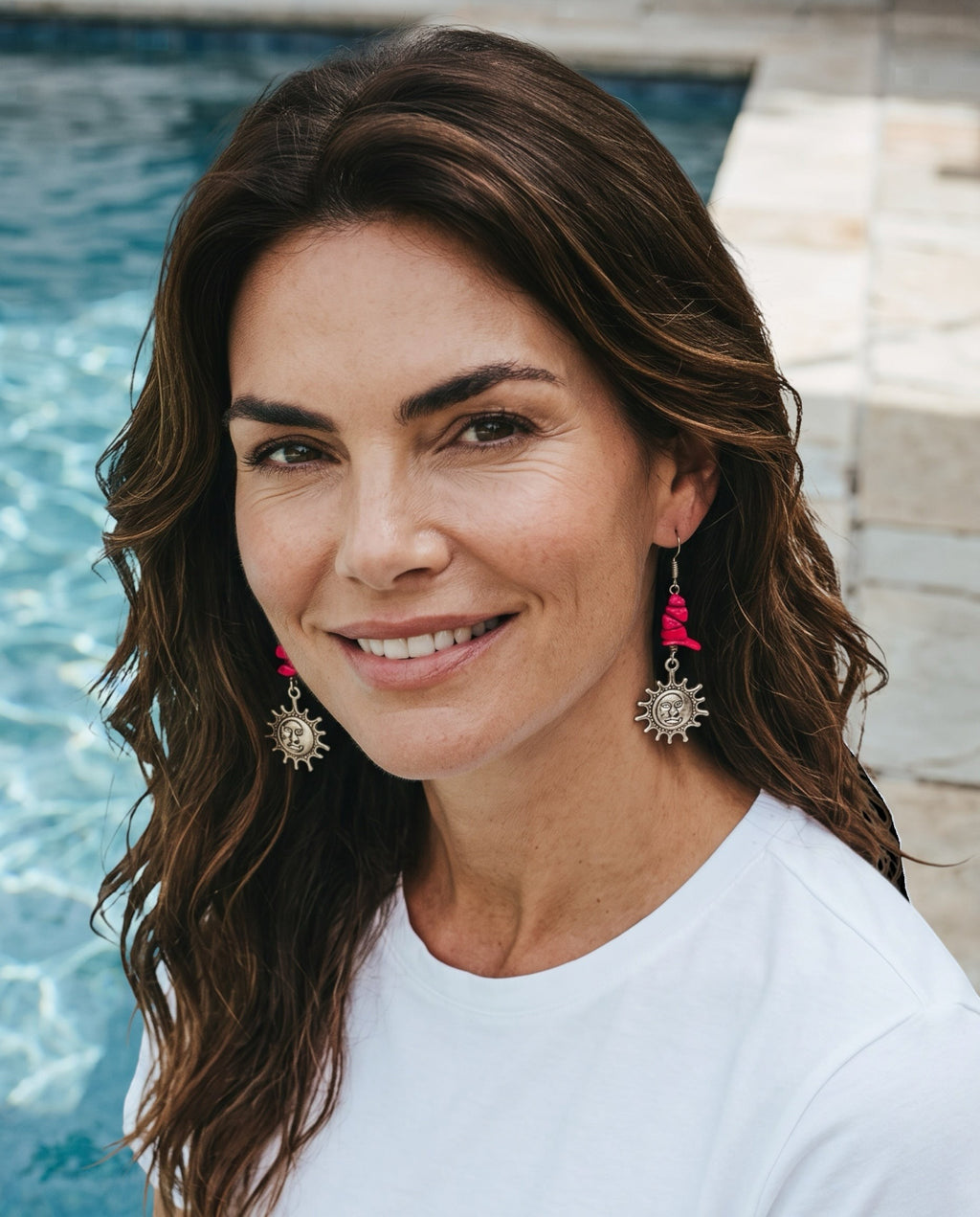 Heartfelt Creations Celestial Sun Drop Earrings with hot pink stone chips and antique silver sun pendants on a model