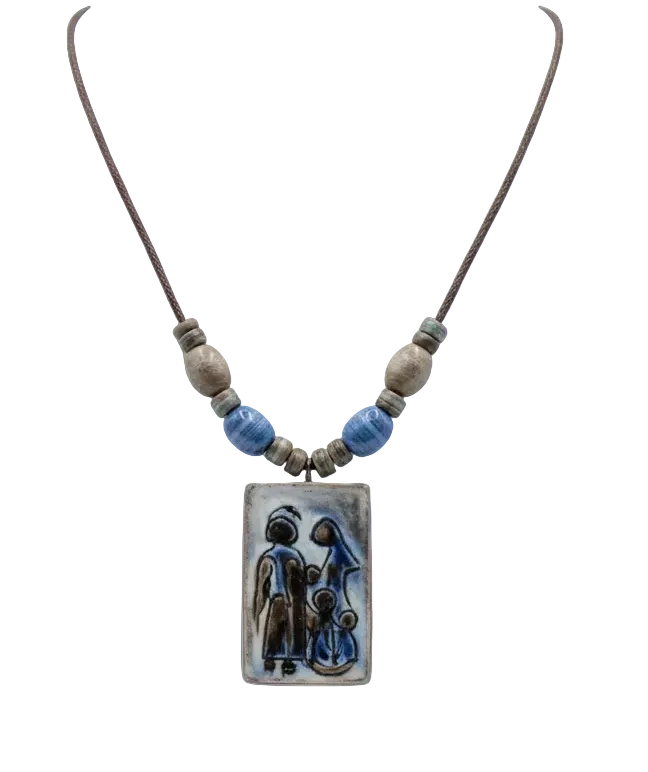 A ceramic pendant necklace featuring a painted scene of a mother and child, suspended on a braided cord with blue and beige beads.