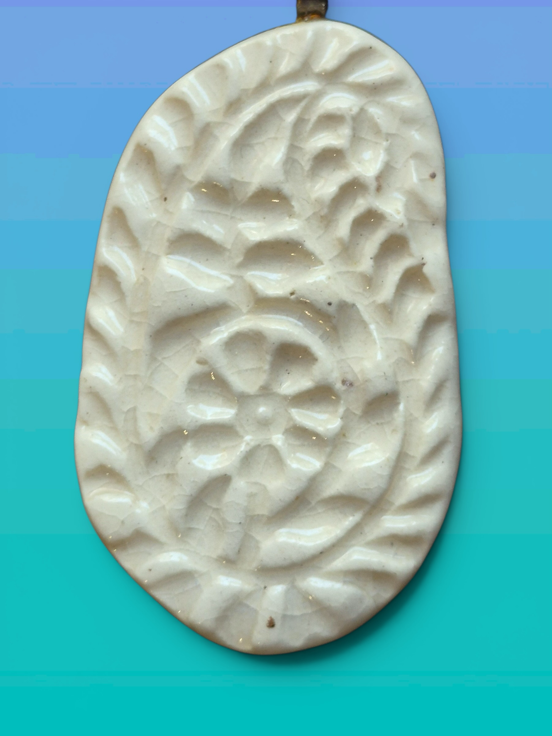 Heartfelt Creations off-white ceramic pendant necklace with embossed floral motif and vintage crackle-glaze finish.