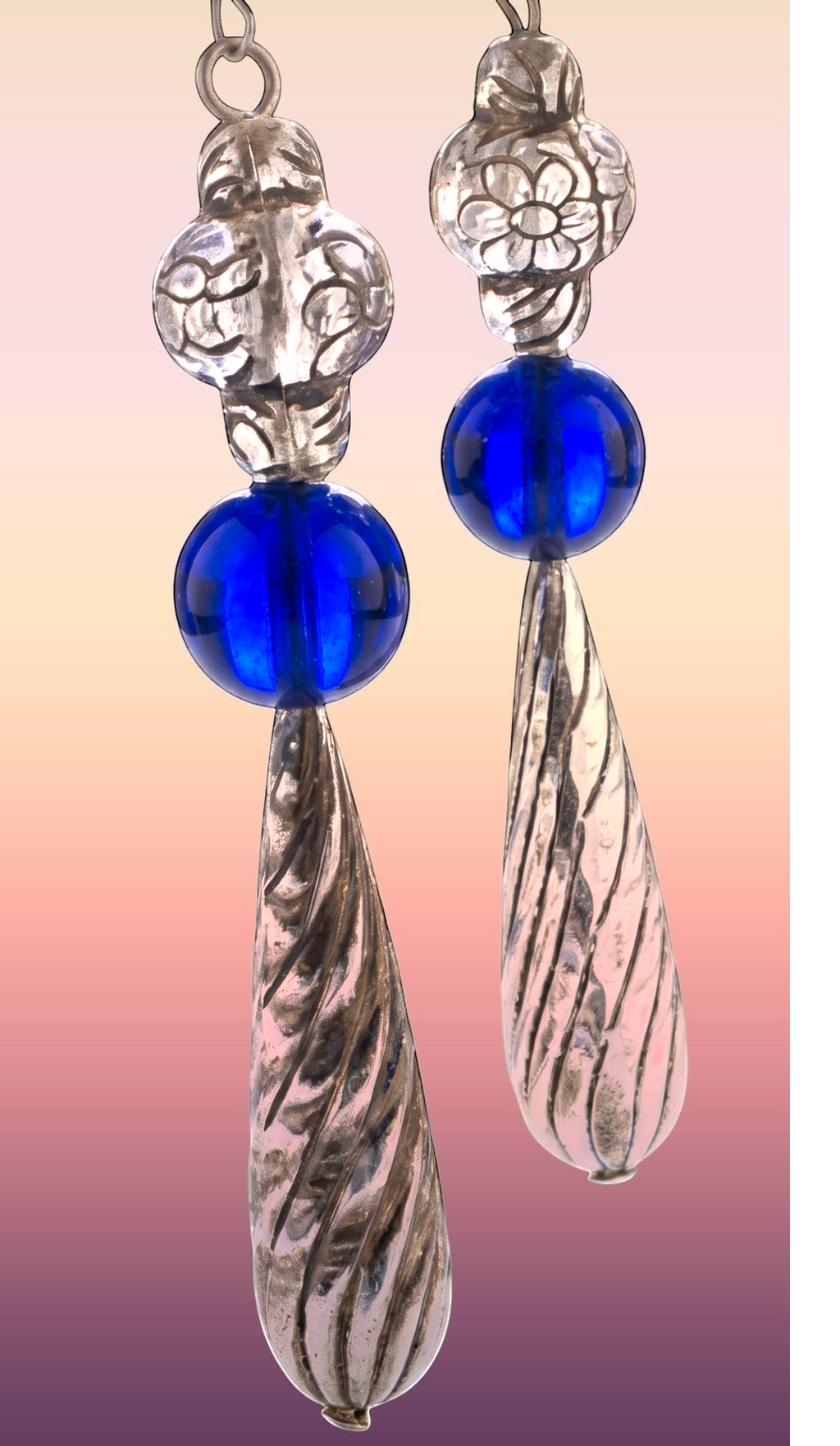 Heartfelt Creations artisan drop earrings with silver floral beads, cobalt blue glass spheres, and twisted pendants.