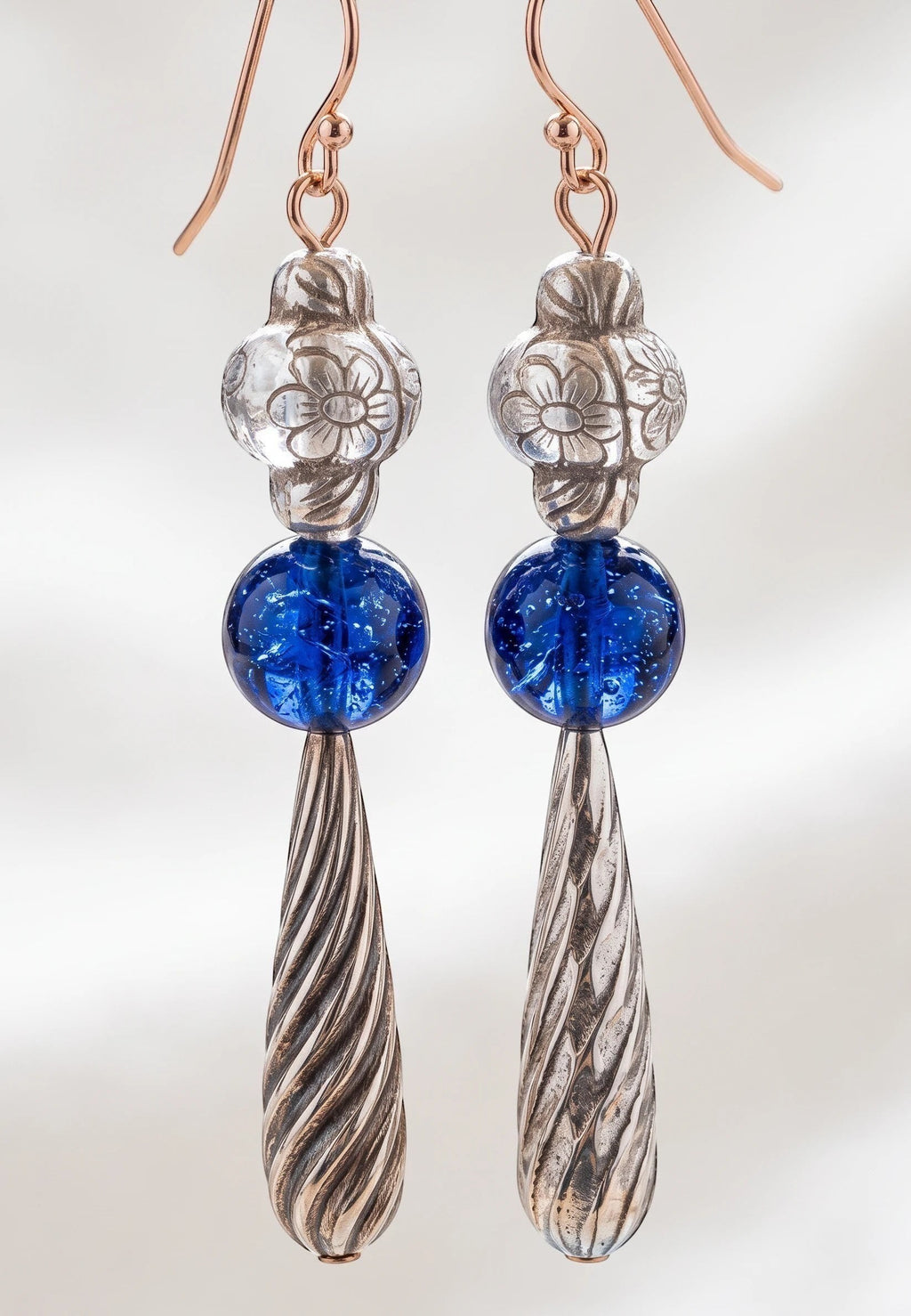 Heartfelt Creations artisan drop earrings featuring silver floral beads, cobalt blue glass spheres, and twisted pendants