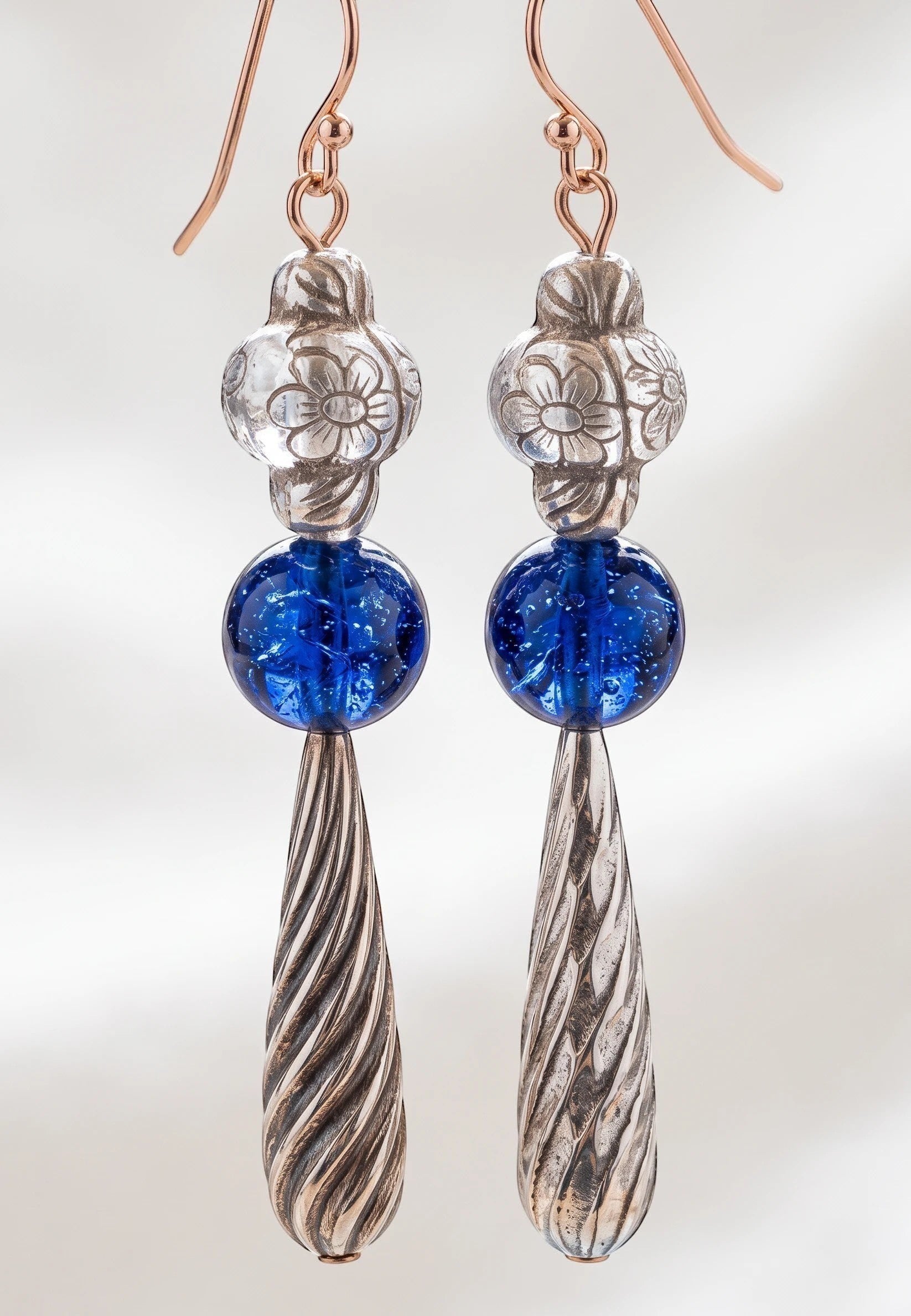 Heartfelt Creations artisan drop earrings featuring silver floral beads, cobalt blue glass spheres, and twisted pendants