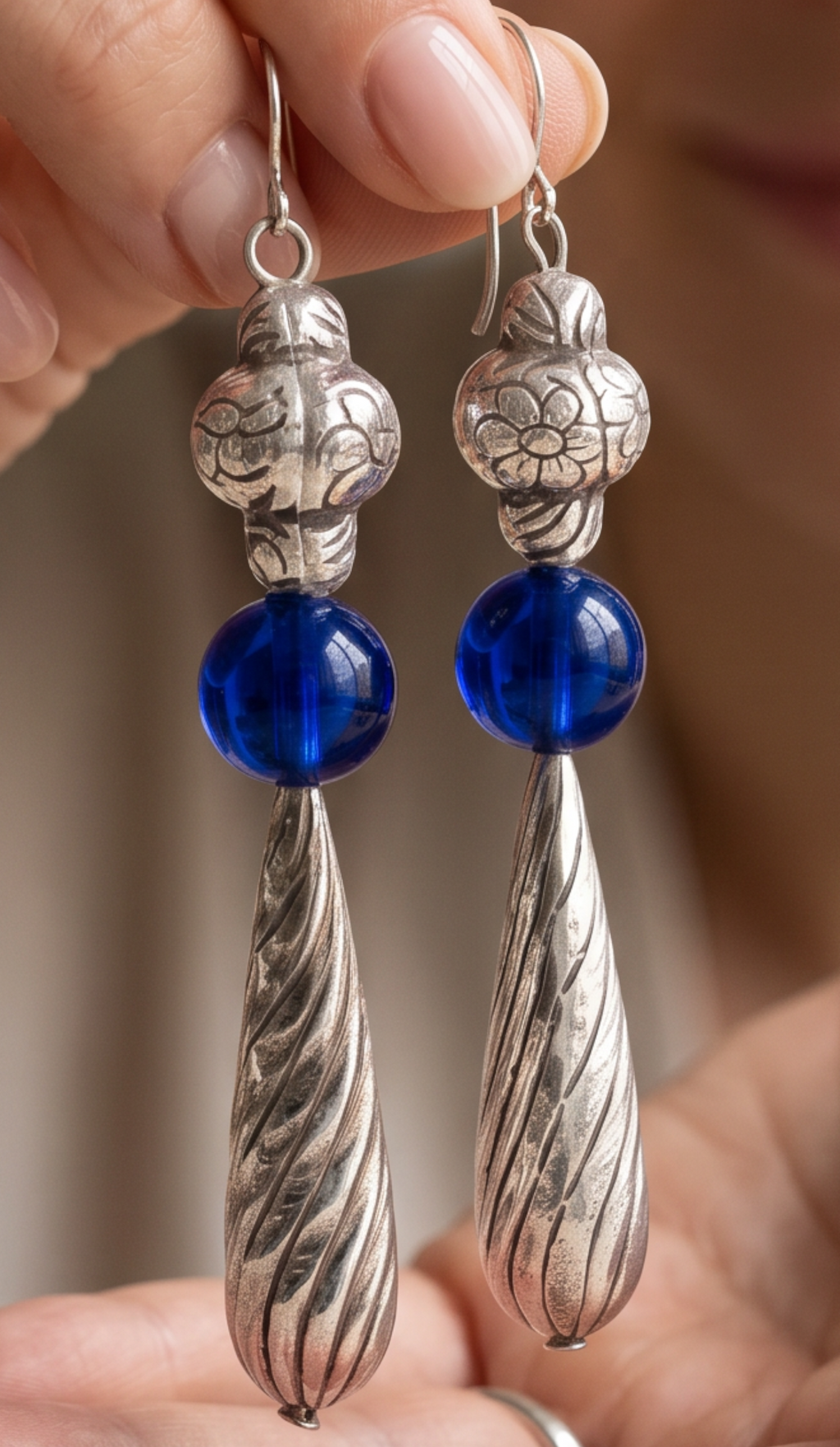 Heartfelt Creations artisan drop earrings featuring silver floral beads, cobalt blue glass spheres, and twisted pendants.