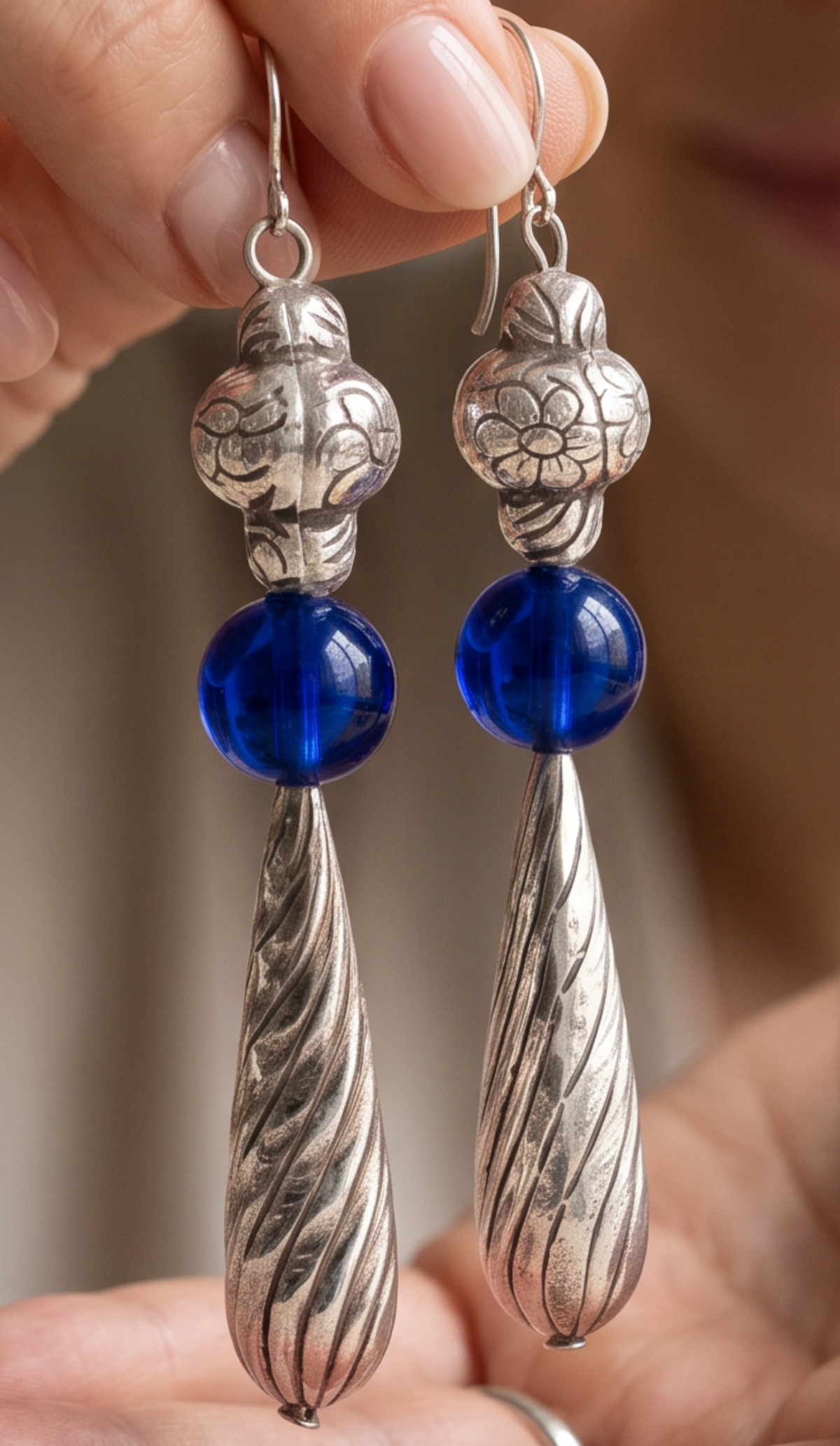 Heartfelt Creations artisan drop earrings featuring silver floral beads, cobalt blue glass spheres, and twisted pendants.