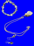 Heartfelt Creations silver-tone jewelry set with blue-grey crystal beads, iridescent pendant necklace, drop earrings, and bracelet.