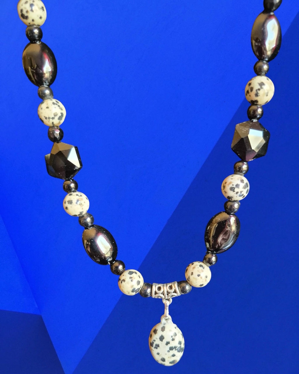 Heartfelt Creations beaded necklace featuring black, white, and Dalmatian Jasper stone beads with a central pendant.