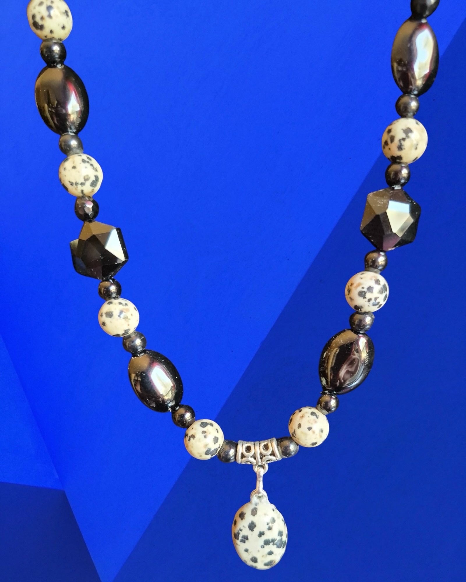 Heartfelt Creations beaded necklace featuring black, white, and Dalmatian Jasper stone beads with a central pendant.