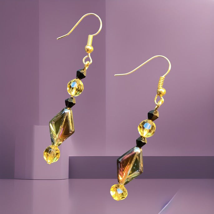 Heartfelt Creations artisan dangle earrings featuring iridescent dichroic glass beads with amber and black accents.