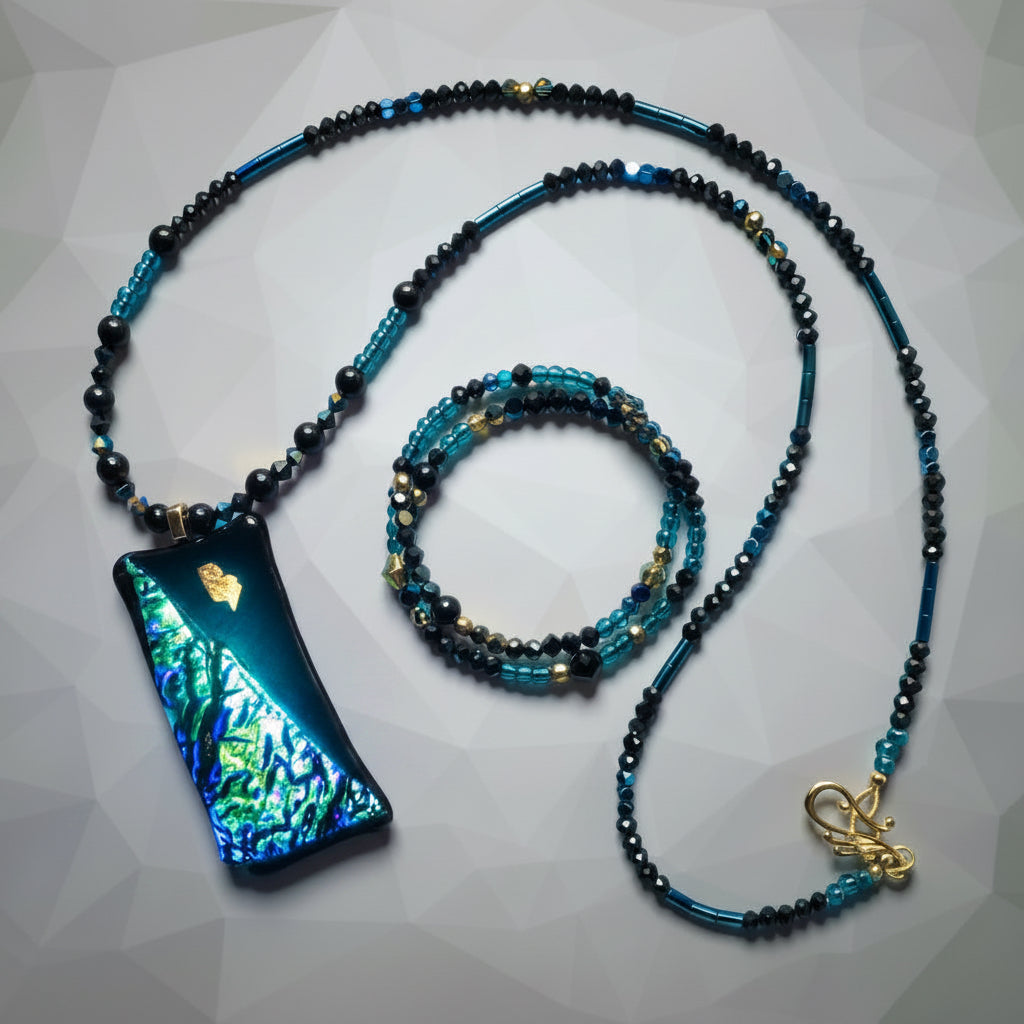 Heartfelt Creations artisan jewelry set featuring a dichroic glass pendant necklace and matching beaded wrap bracelet.