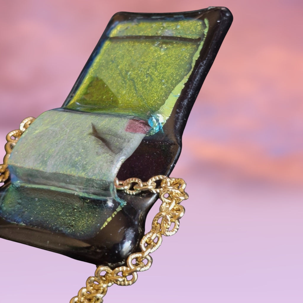 Heartfelt Creations handcrafted dichroic glass pendant in green and black on a delicate gold-tone chain.