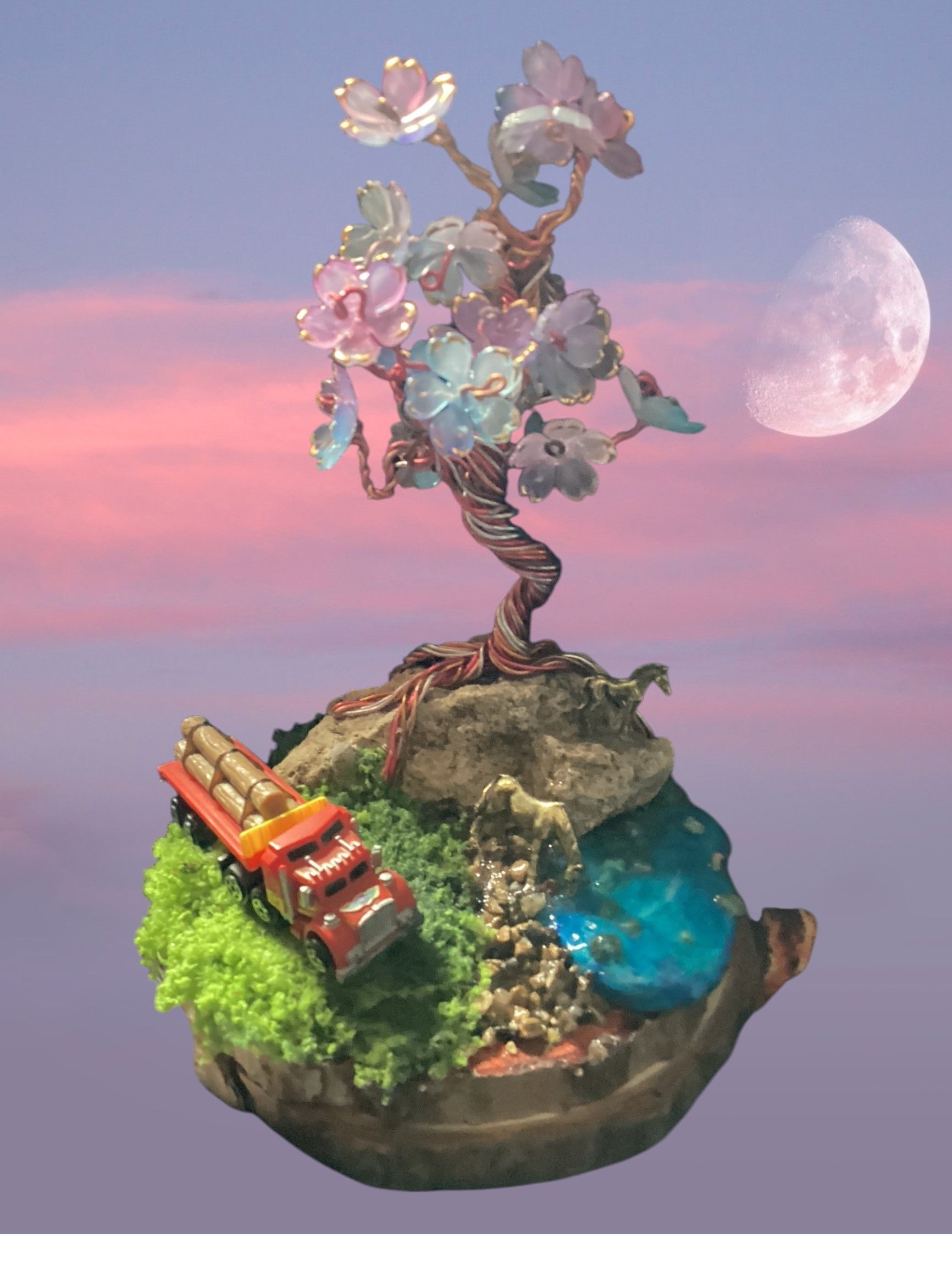Heartfelt Creations miniature diorama with wire-wrapped tree, pastel blossoms, moss, blue water, and red logging truck.