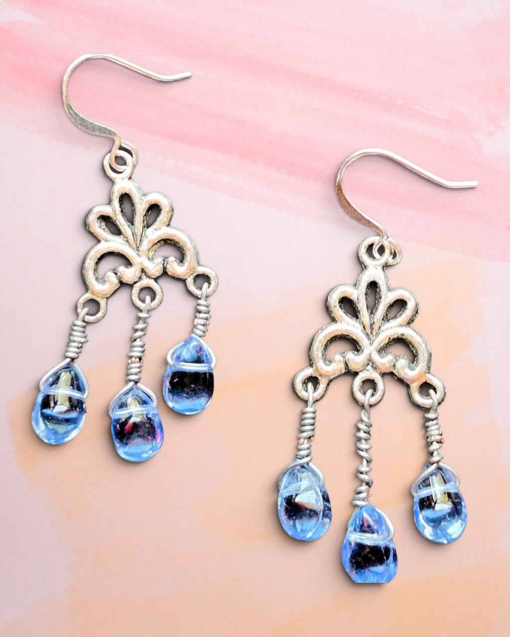 Heartfelt Creations vintage-style silver filigree dangle earrings with translucent blue teardrop beads.