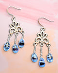 Heartfelt Creations vintage-style silver filigree dangle earrings with translucent blue teardrop beads.