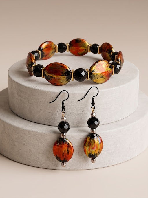 Heartfelt Creations artisan jewelry set featuring a fire-colored beaded bracelet and matching drop earrings.