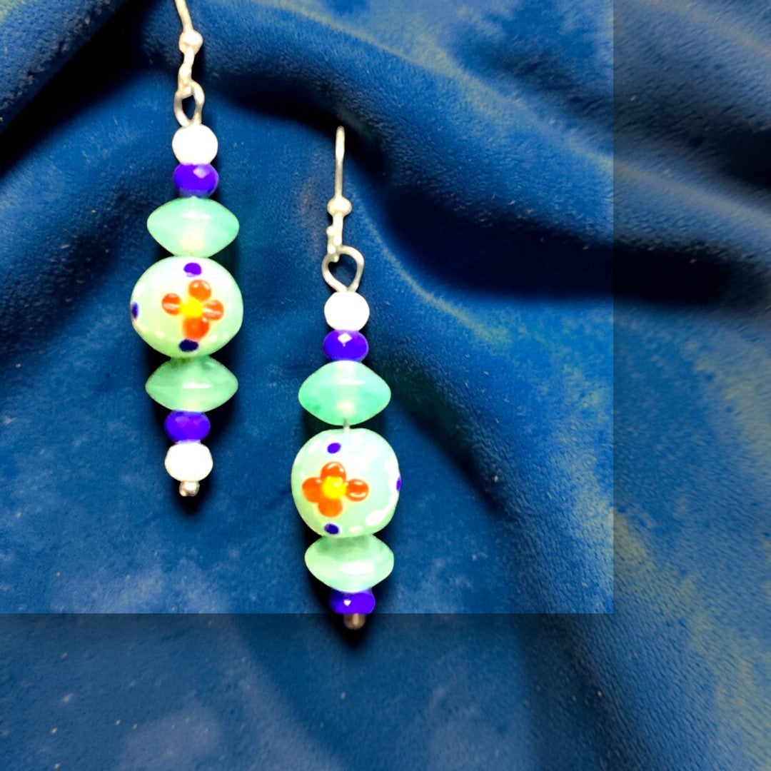 Heartfelt Creations handcrafted dangle earrings with mint green, purple, and white beads and floral motifs.