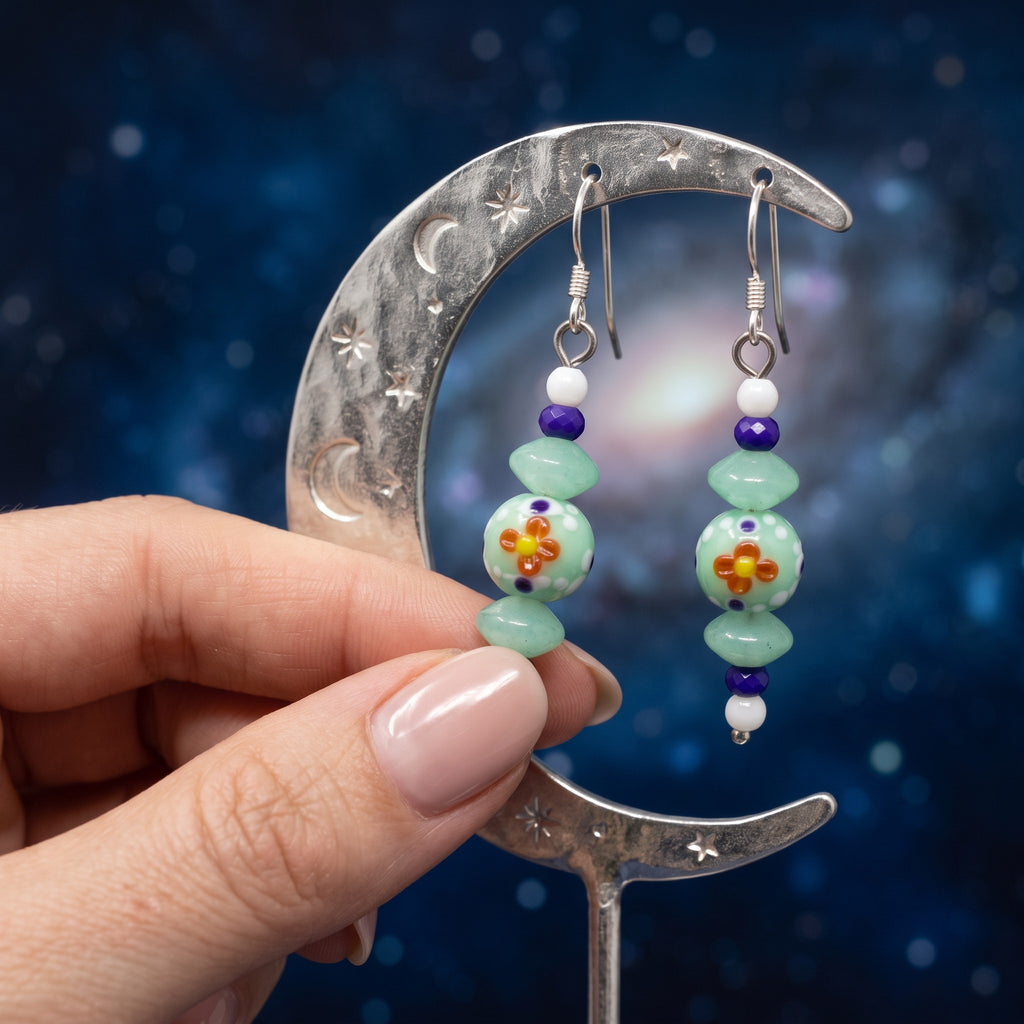 Heartfelt Creations handcrafted dangle earrings with mint green, purple, and white beads featuring floral motifs