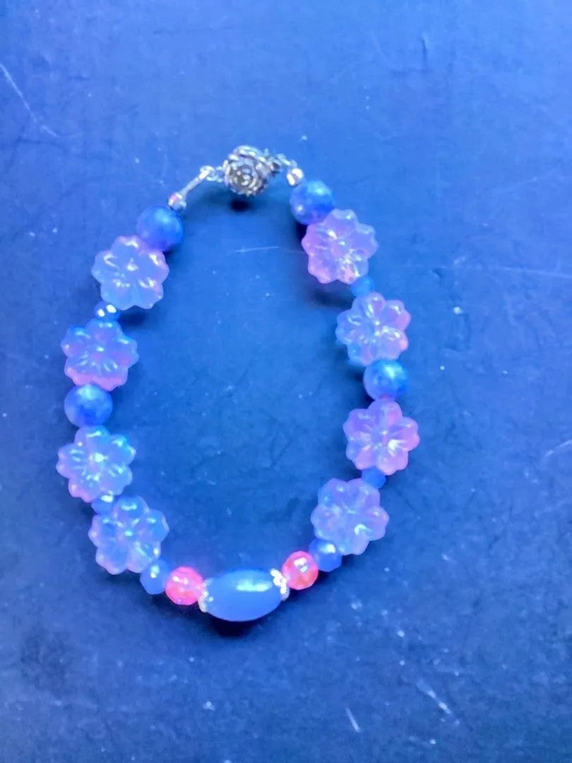 Heartfelt Creations floral beaded charm bracelet with iridescent floral charms, lavender, blue, and pink beads.