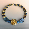 Heartfelt Creations multi-strand wrap bracelet with gold beads, navy blue accents, and a metallic rose charm centerpiece.