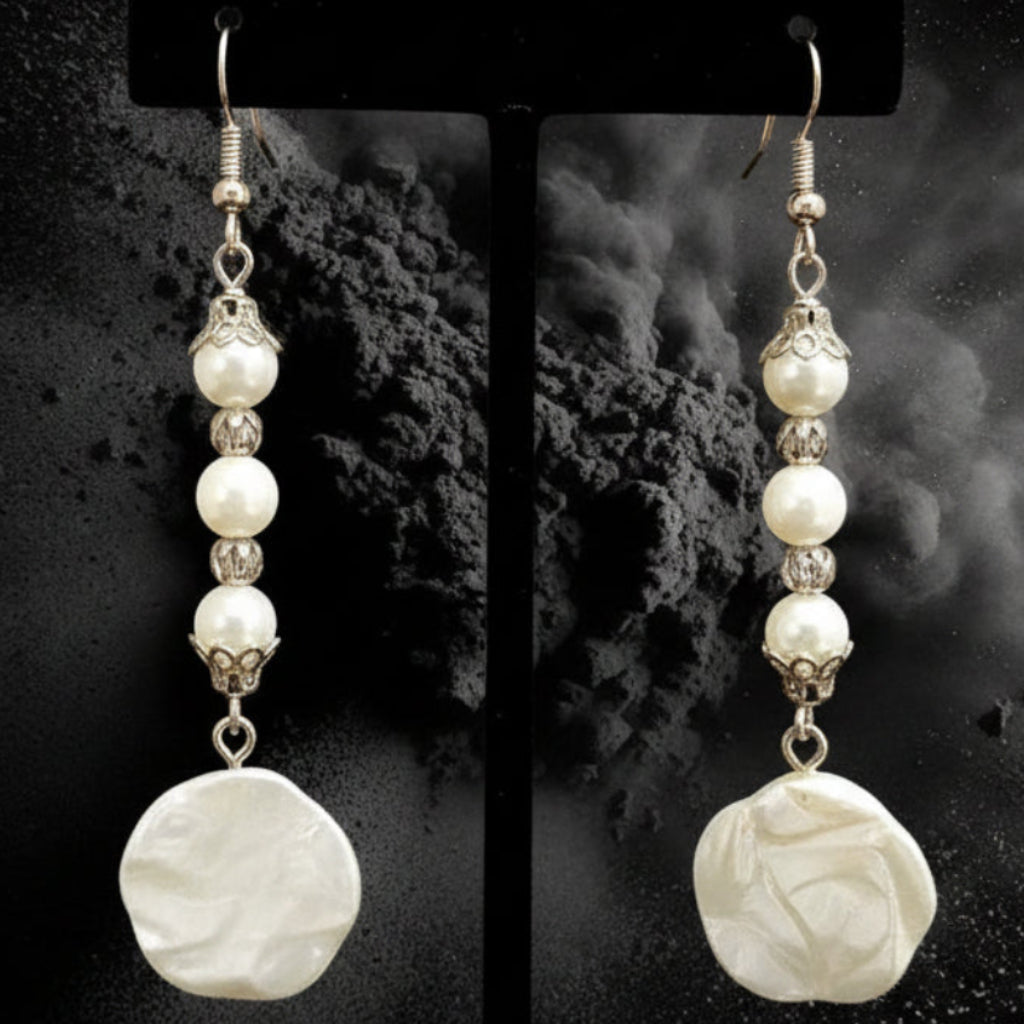 Heartfelt Creations elegant floral pearl drop earrings with vintage-inspired filigree caps on a dark textured background