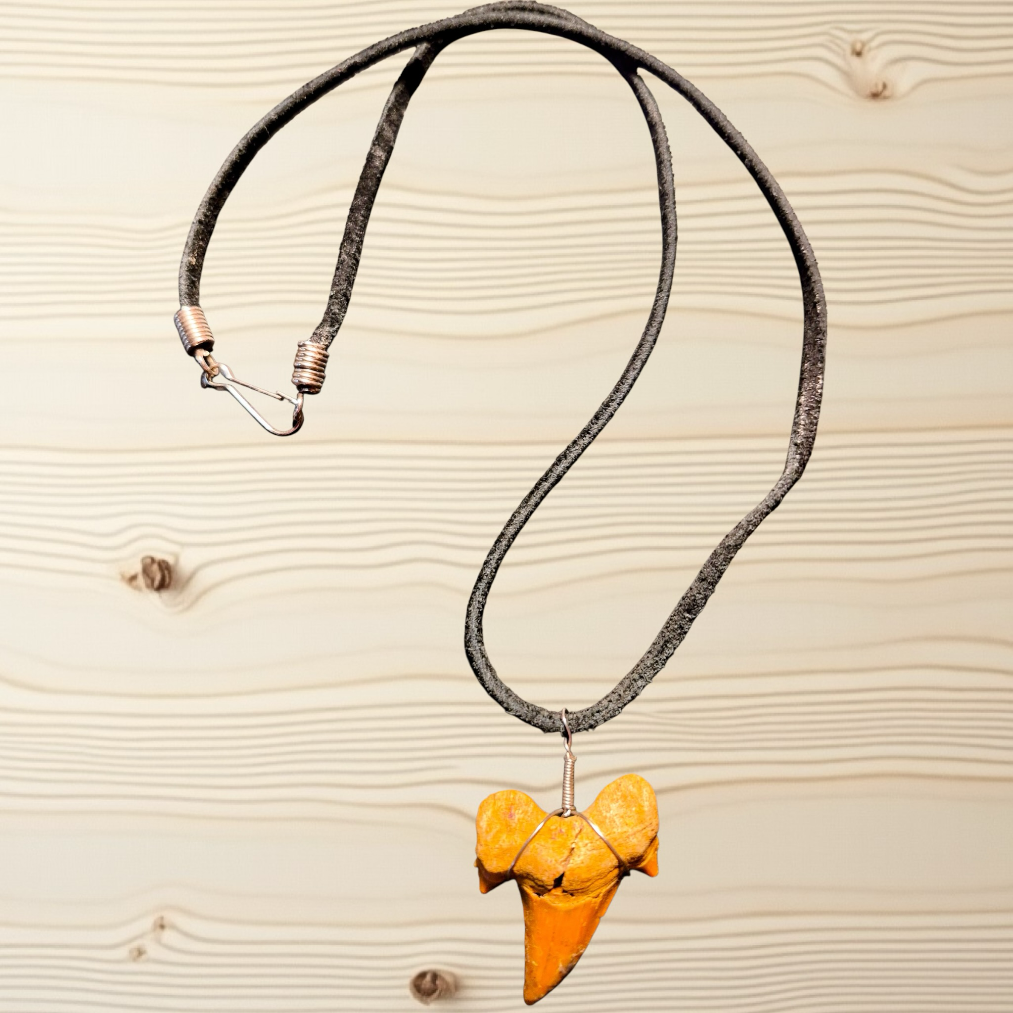 Heartfelt Creations genuine fossilized shark tooth pendant necklace in ochre, wrapped in silver-tone wire on a dark cord.
