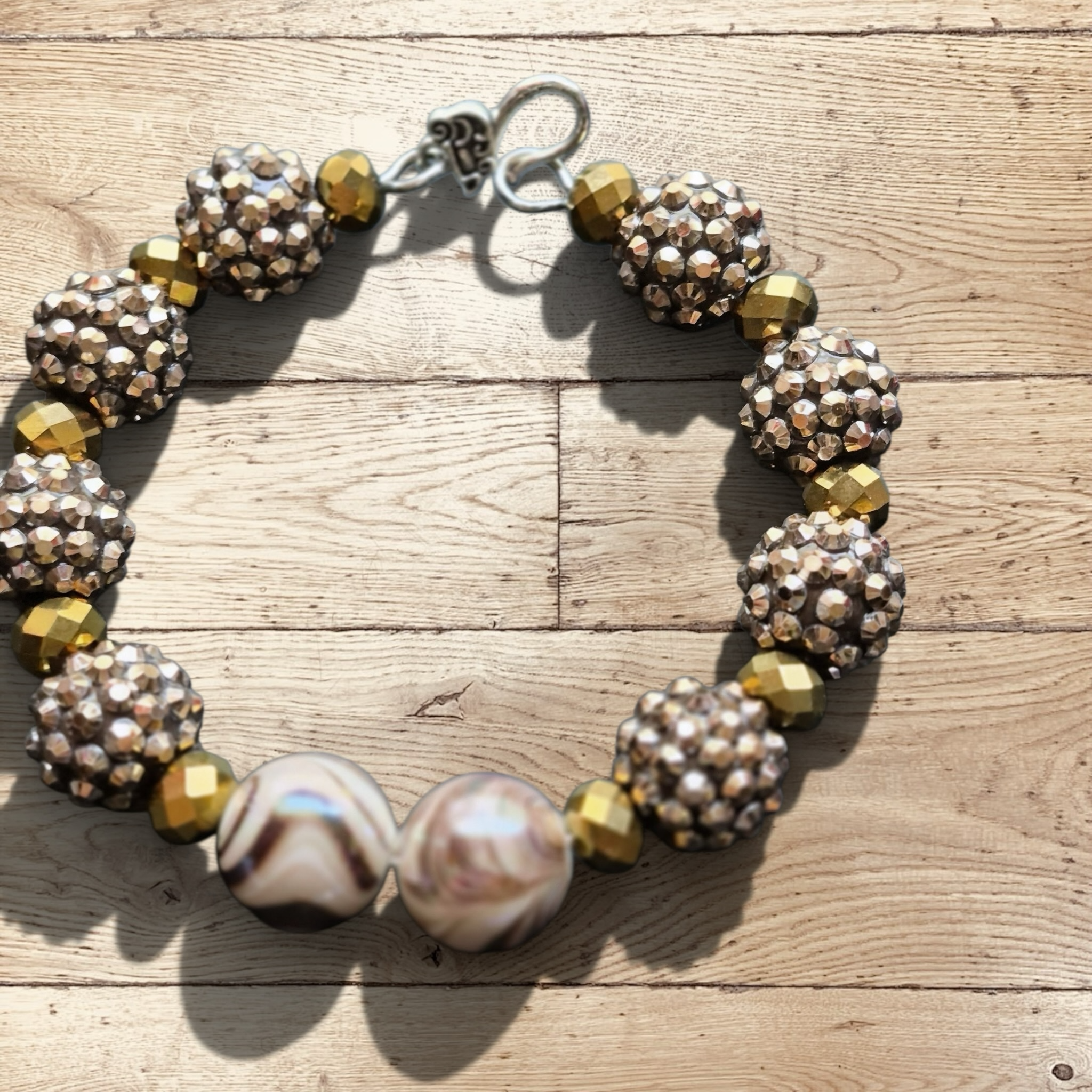 Heartfelt Creations handmade bracelet with large marbled beads, gold-tone faceted beads, and champagne rondelles.