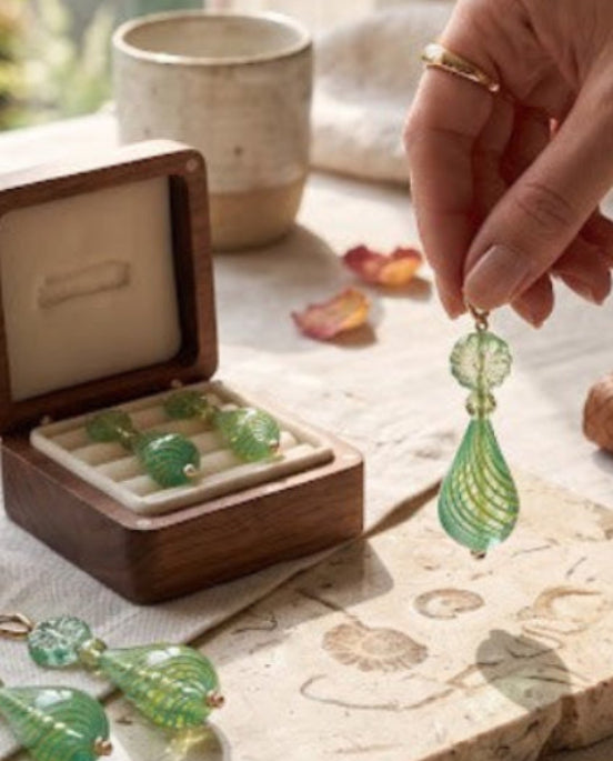 Heartfelt Creations artisan glass teardrop earrings in teal and lime green with swirling patterns and floral beads.